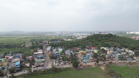 Aerial-Shot-of-Hill-Surrounded-by-Small-Houses-in-Indian-City