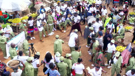 Cultural-dance-and-traditional-celebration-at-a-fruit-and-vegetable-market-in-Makurdi,-Nigeria---aerial