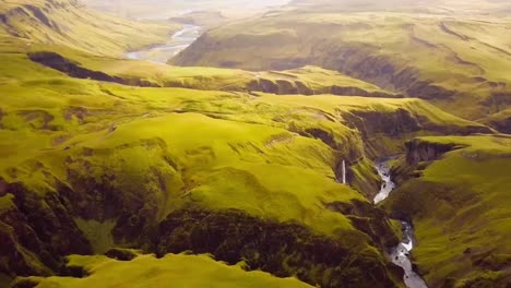4K-drone,-aerial-cinematic-shots-of-the-landscape-images-below-the-Kirckjufell-mountain-in-Iceland-with-a-cascading-waterfall-in-the-middle