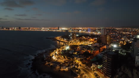 Mazatlán-Malecon-oceanfront-seawall-promenade,-moody-evening-in-Mexico---Aerial-view