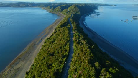 Aerial-shot-of-Lemuy-Island-showcasing-the-narrow-land-strip-with-ocean-on-both-sides-at-sunset