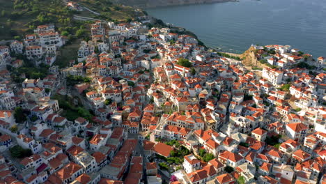 Aerial:-Panoramic-view-of-Skopelos-town-in-Sporades,-Greece-during-sunset