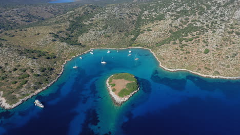 Aerial:-Panoramic-view-of-paradise-bay-of-the-island-of-Kira-Panagia-in-Sporades,-Greece-with-amazing-turquoise-and-emerald-crystal-clear-sea