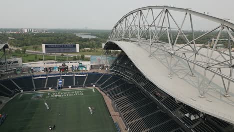 Aerial-Drone-Grey-Metal-Scaffolding-Roof-on-Massive-Football-Sports-Arena-Stadium