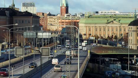 Car-and-train-traffic-in-evening-sunlight-in-central-Stockholm,-Sweden
