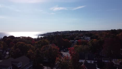 Aerial-of-Ogunquit-Main-USA-drone-fly-above-traffic-road-and-revealing-scenic-coastline-during-sunny-day