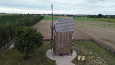 old-wooden-windmill-medieval-aerial-circulating-left-cloudy-day