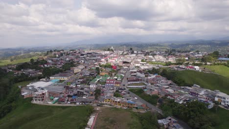 Panorama-aerial-orbit-small-town-Filandia-in-Colombia-in-the-Andes,-cloudy-day