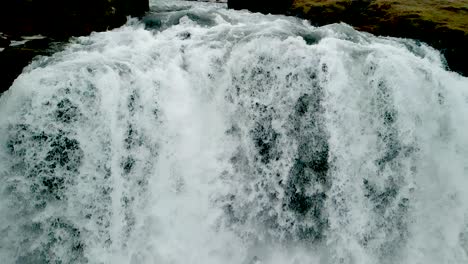 An-Extreme-closeup,-4K-Drone,-Aerial,-cinematic-shots-of-cascading-waterfalls-that-form-like-a-curtain-in-the-Iceland-mountain