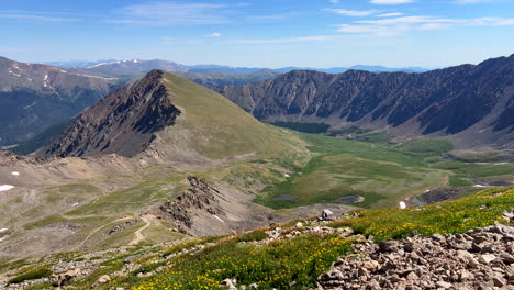 Grays-and-Torreys-peak-trail-i70-wildflowers-fourteener-14er-June-July-Summer-Colorado-blue-sky-Rocky-Mountain-landscape-snow-melting-Continental-Divide-early-morning-pan-left-slowly