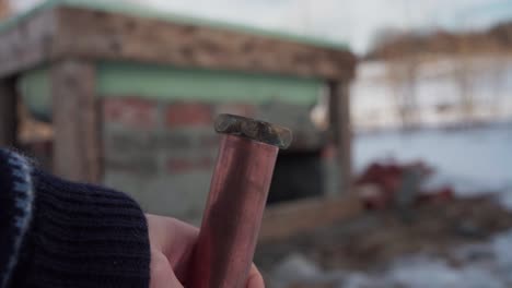 The-Man-is-Examining-the-Pipe-Intended-for-the-Construction-of-the-DIY-Hot-Tub---Close-Up