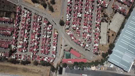 Drone-flight-with-overhead-view-of-a-neighborhood-in-the-municipality-of-Cuautitlan-Izcalli,-near-Mexico-City