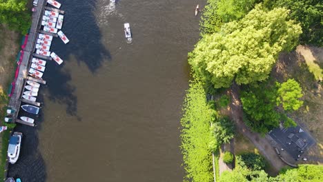 Experience-the-vibrant-energy-of-summer-in-Berlin-with-breathtaking-aerial-footage-over-the-Spree-River,-capturing-bustling-boat-traffic-and-lush-green-parks