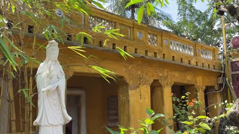 White-Buddhist-Statue-in-yellow-Buddhist-Temple-in-Hoi-AN-UNESCO-site,-Vietanam