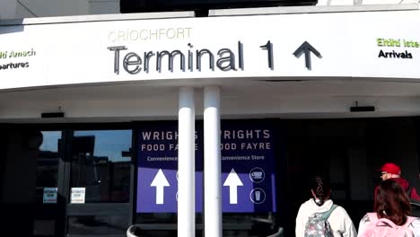 Three-friends-entering-to-the-Airport-Terminal-in-Dublin-to-take-a-flight