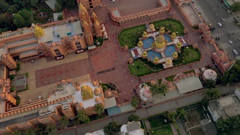 Aerial-drone-view-camera-is-running-behind-there-are-lots-of-houses-behind-the-temple-and-a-grand-very-beautiful-looking-temple