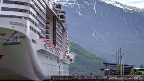 Un-Crucero-Flotando-En-El-Muelle-De-Un-Puerto-De-Noruega,-Con-El-Fiordo-Al-Fondo.