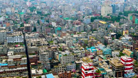 Rising-aerial-shot-over-dense-and-colorful-megacity-of-Dhaka,-Bangladesh