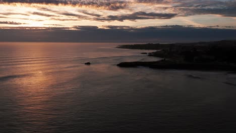 Late-sunset-drone-shot-of-a-beautiful-sunset-in-Santa-Cruz,-California