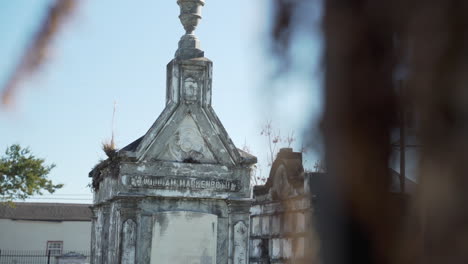 An-old-grave-within-Lafayette-Cemetery-#2-in-New-Orleans,-Louisiana-on-a-sunny,-cold-winter-day