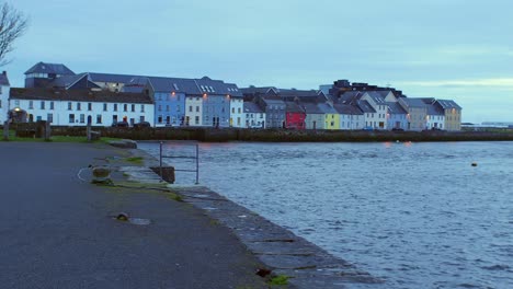 POV-shot-gliding-through-Claddagh-Basin-with-picturesque-views-of-"The-Long-Walk"-in-Galway