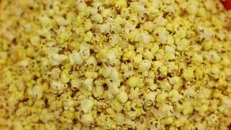 pov-shot-close-up-seen-mixing-in-a-roller-and-removing-popcorn-in-a-big-bucket-close-up-seen