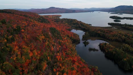 aerial-shot-over-typical-canadian-landscape-during-fall-in-Quebec,-Mont-Sourire-and-Lake-Ouareau,-autumn,-Quebec-province,-Canada