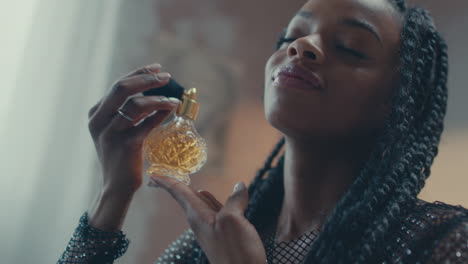African-model-girl-applying-vintage-perfume-on-her-at-her-bedroom