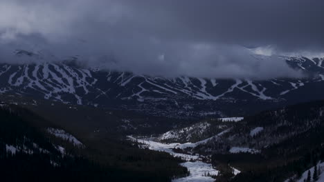 Ten-Mile-Breck-Peaks-Breckenridge-Ski-resort-town-Vail-Epic-Ikon-Pass-aerial-drone-landscape-cloudy-fog-sunny-winter-morning-ski-trail-runs-Summit-County-Tiger-fork-road-Rocky-Mountains-down-motion