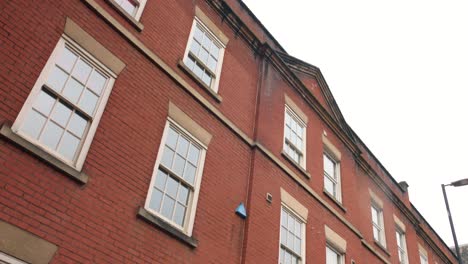 Red-brick-facade-with-windows-of-typical-english-Manchester-city-house