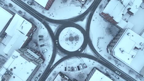 Snowy-aerial-view-of-a-small-town-square-with-roundabout-roads-in-the-USA