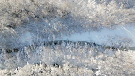 aerial-pan-of-frozen-river-running-through-the-mountains