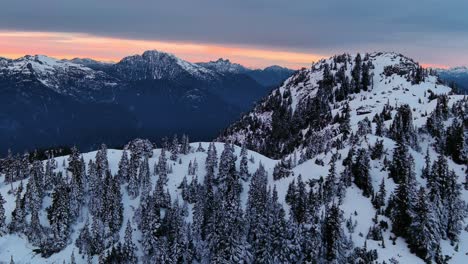 Scenic-Snowy-Mountain-and-Tree-Landscape,-Colorful-Sunset-Sky