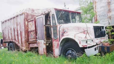 An-old-Garbage-truck-left-to-the-elements-in-an-open-field