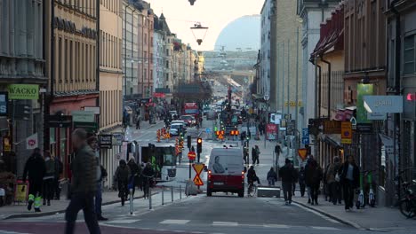 Car,-bike-and-pedestrian-traffic-on-busy-street-in-Stockholm,-Sweden