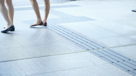 Two-women-leaveing-the-building-and-going-through-glass-doors