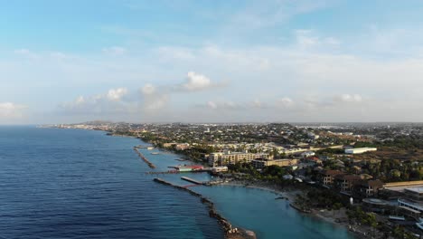 Coastline-by-Mambo-Beach-on-Caribbean-island-Curaçao,-wide-aerial-pan