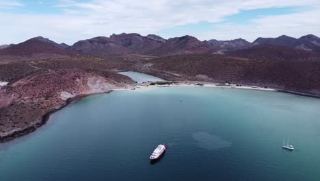 Playa-balandra,-baja-california-with-a-boat-and-clear-waters,-aerial-view