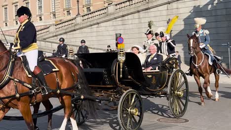 King-and-Queen-of-Sweden-in-horse-carriage-on-National-Day,-slo-mo