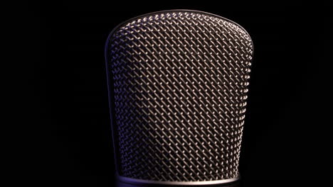 Professional-Radio-and-Studio-Microphone,-Spinning-on-Black-Background,-Close-Up