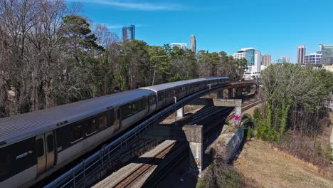 Riding-train-on-track-in-suburb-area-of-Atlanta-City-during-sunny-day