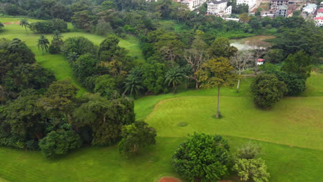 Aerial-tracking-shot-overlooking-trees-and-lawn-at-a-Golf-course-in-Yaounde,-Cameroon