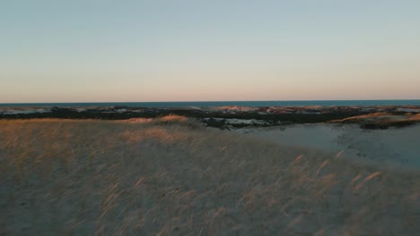 Slow-establishing-shot-of-the-vast-Provincetown-Dunes-at-sunset-in-Massachusetts