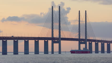 K-Line-European-Sea-Highway-Services-vessel-cruise-under-Oresund-bridge,-sunset