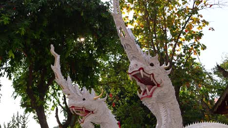 Close-up-of-white-marbled-Naga-Statues-with-sun-flares