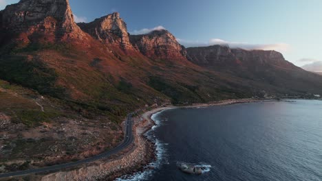 Aerial-View-Over-Coastal-Road-With-Twelve-Apostles-Mountain-In-Cape-Town,-South-Africa---Drone-Shot