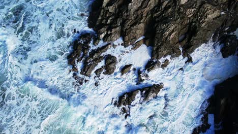 Ocean-Waves-in-Slow-Motion-Crashing-Over-Cornish-Rocks-with-Top-Down-View-Overhead