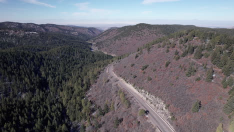 Drone-shot-of-a-mountain-highway-and-pine-tree-forest
