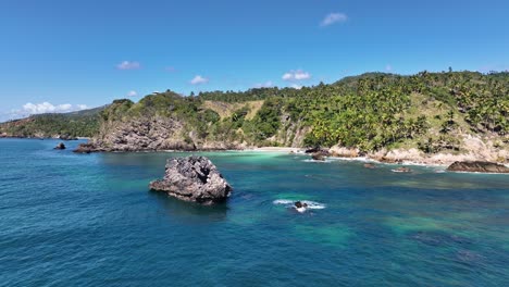 Paradise-Caribbean-beach-on-a-sunny-day,-Samaná,-Dominican-Republic,-low-angle-drone-shot
