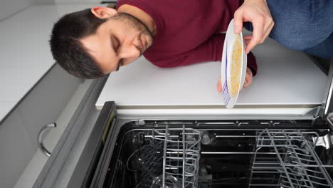 Man-holding-a-dirty-plate,-disappointed-by-dishwasher